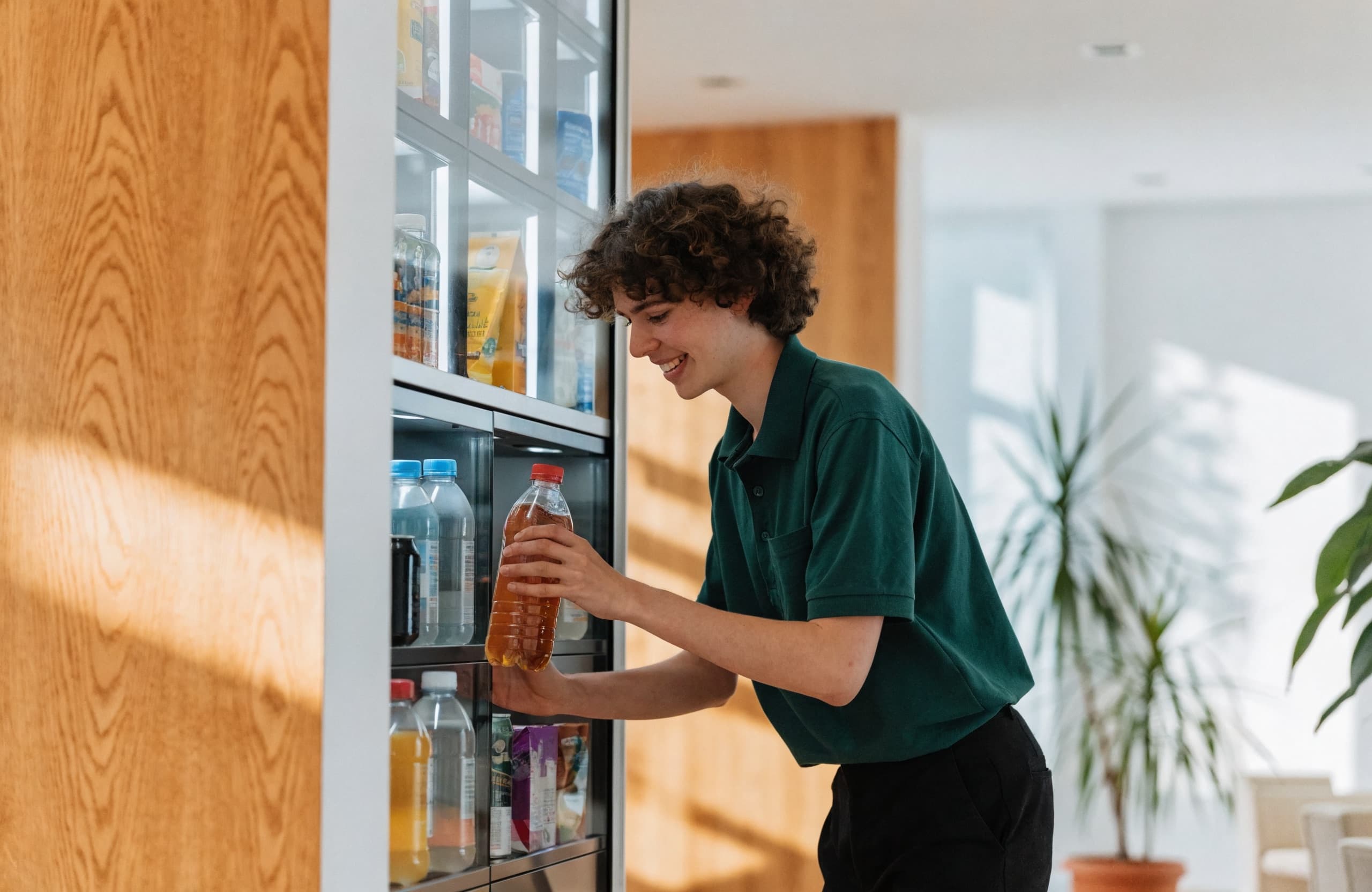 A friendly Quickstop technician restocking a smart vending machine